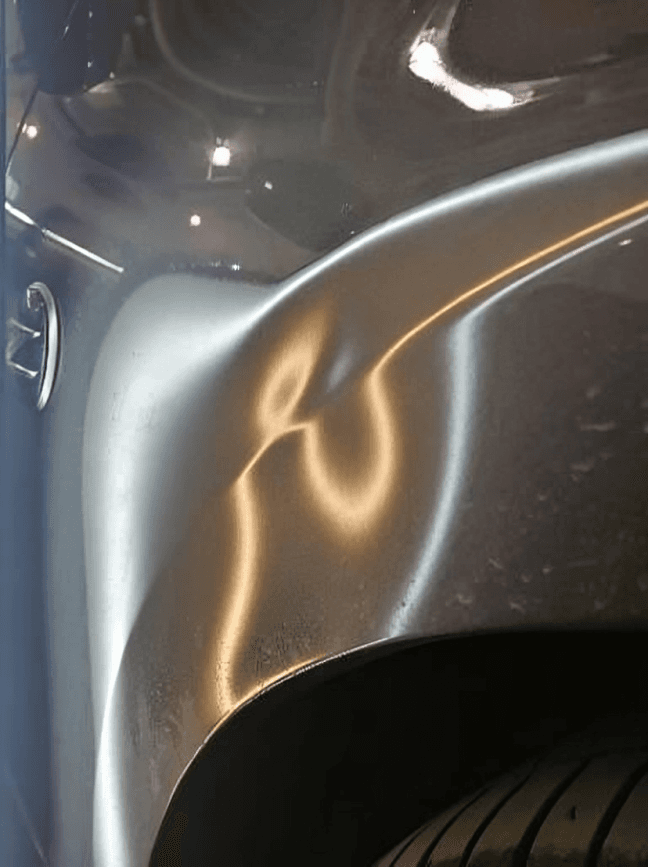 Car door panel with a visible dent